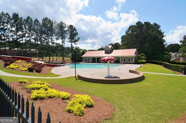 view of swimming pool featuring a yard and a patio area