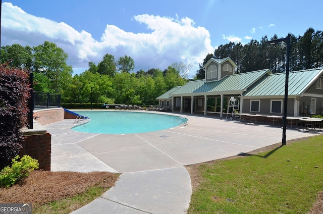 view of swimming pool featuring a patio area