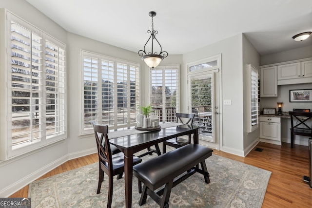 dining space featuring light wood-type flooring