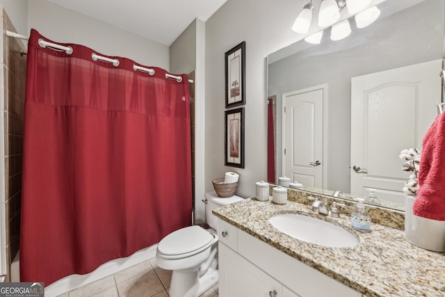 bathroom with tile patterned flooring, vanity, and toilet