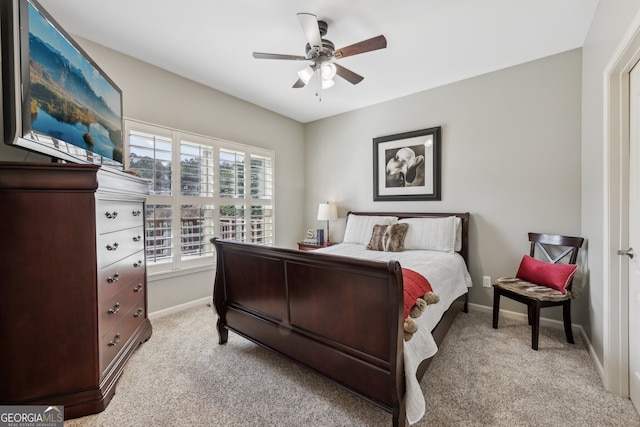 bedroom with ceiling fan and light colored carpet