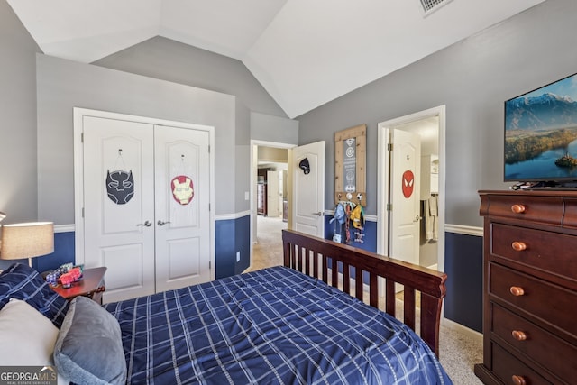 bedroom featuring lofted ceiling, carpet floors, and a closet