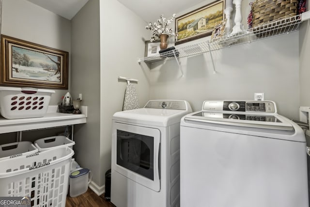 clothes washing area with separate washer and dryer and dark hardwood / wood-style floors