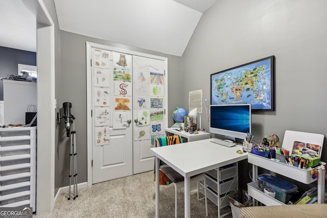 carpeted home office featuring vaulted ceiling