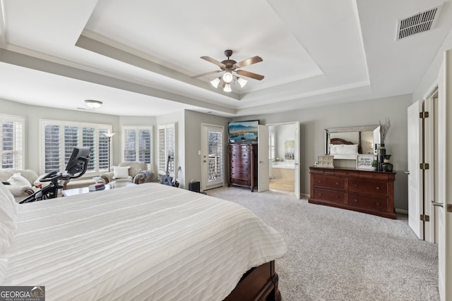 carpeted bedroom with a tray ceiling, access to outside, ornamental molding, and ceiling fan