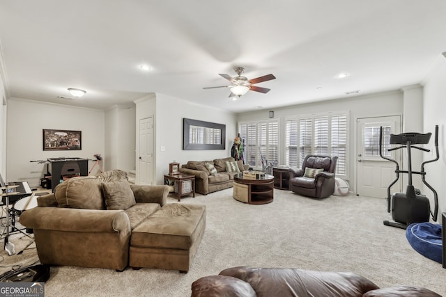 carpeted living room featuring crown molding and ceiling fan