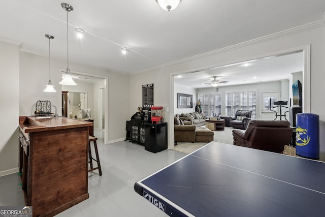 recreation room featuring crown molding and ceiling fan