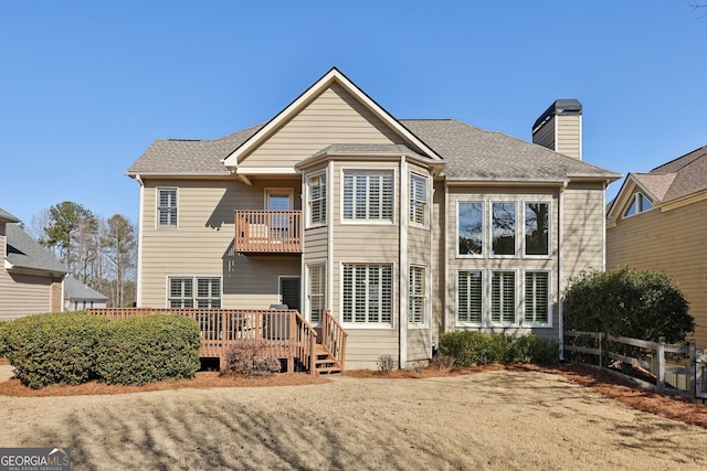 rear view of house featuring a wooden deck