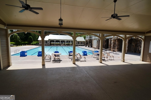 view of swimming pool with ceiling fan and a patio area