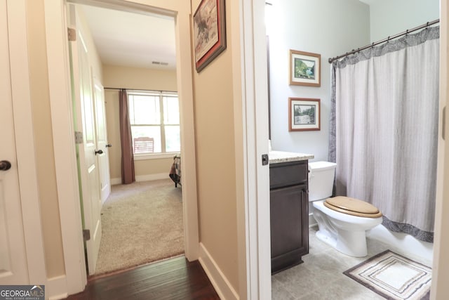 full bathroom featuring vanity, shower / bath combination with curtain, and toilet