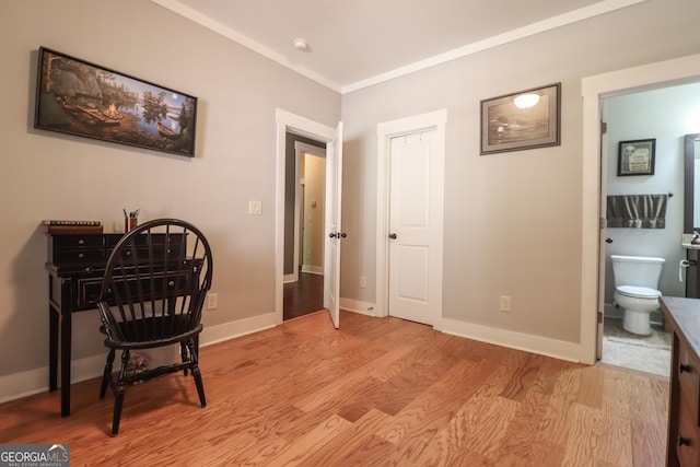 sitting room featuring ornamental molding and light wood-type flooring