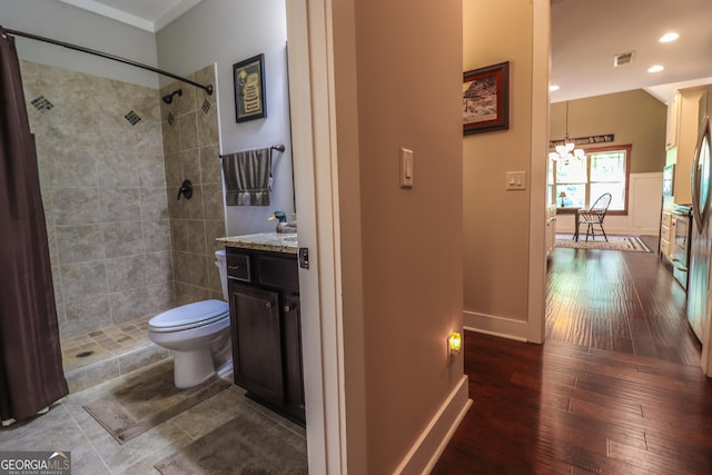 bathroom with vanity, a notable chandelier, wood-type flooring, toilet, and walk in shower