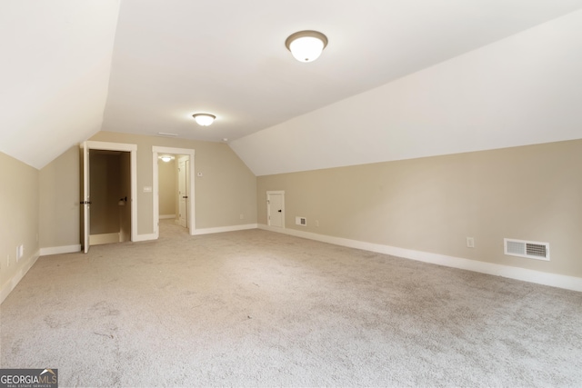 additional living space with lofted ceiling and carpet floors