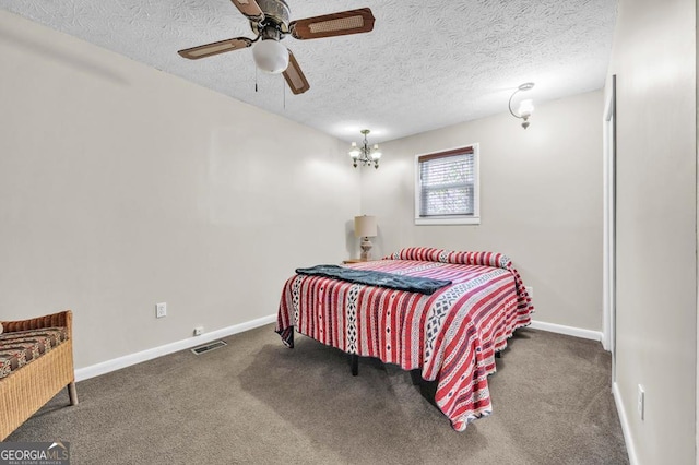 bedroom featuring ceiling fan with notable chandelier, a textured ceiling, and dark carpet