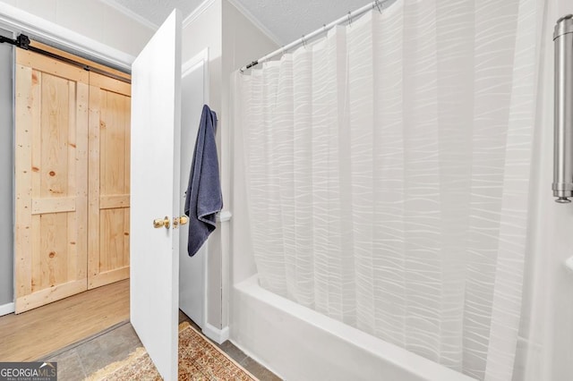 bathroom with crown molding and shower / bath combo