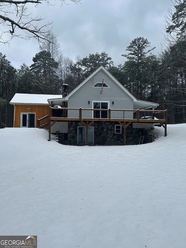 snow covered property featuring a deck