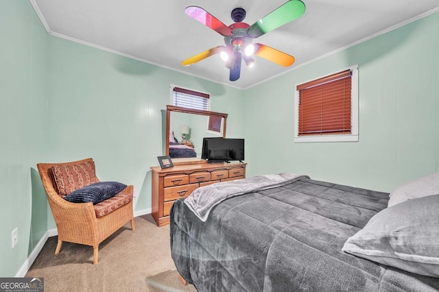 carpeted bedroom featuring crown molding and ceiling fan