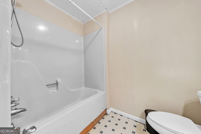 bathroom featuring ornamental molding, bathing tub / shower combination, and toilet