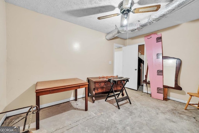 office area with ceiling fan and a textured ceiling