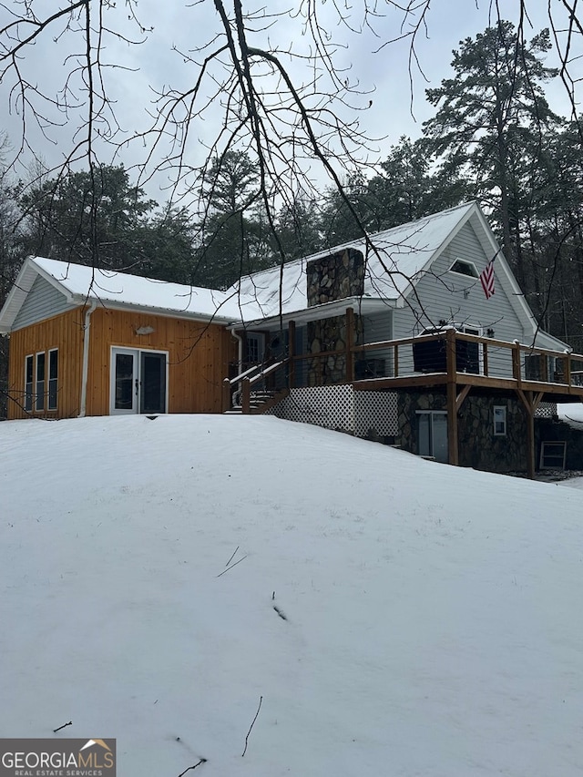 view of snow covered rear of property