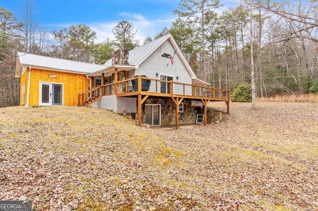 rear view of property featuring french doors and a deck