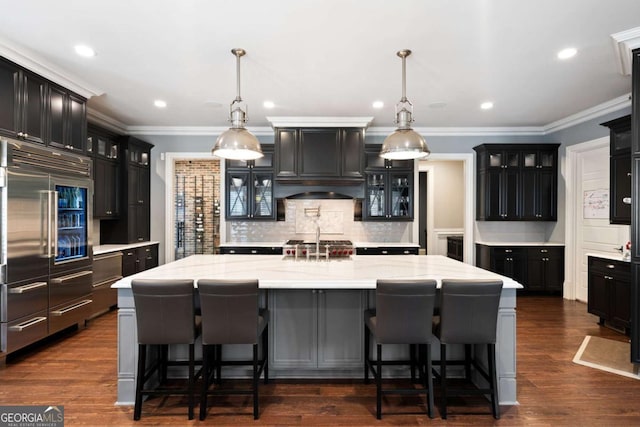 16143 Belford Dr, Alpharetta, GA 30004 - kitchen featuring stainless steel built in refrigerator, decorative backsplash, a large island with sink, ornamental molding, and light stone counters