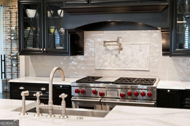 16143 Belford Dr, Alpharetta, GA 30004 - kitchen with range with two ovens, dark cabinets, backsplash, and premium range hood