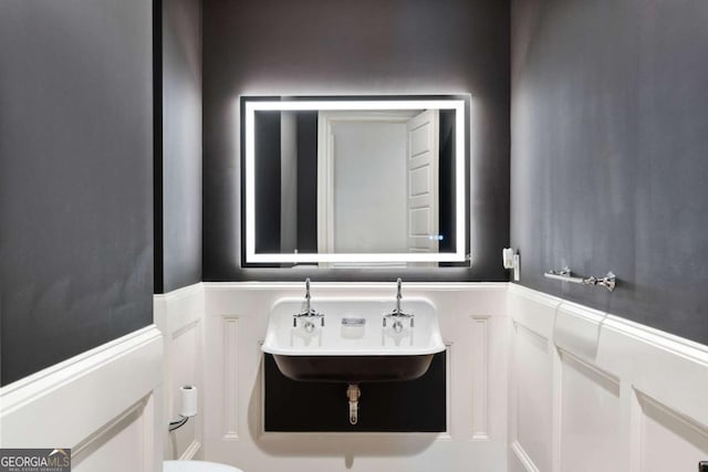 16143 Belford Dr, Alpharetta, GA 30004 - half bathroom with a sink and a wainscoted wall