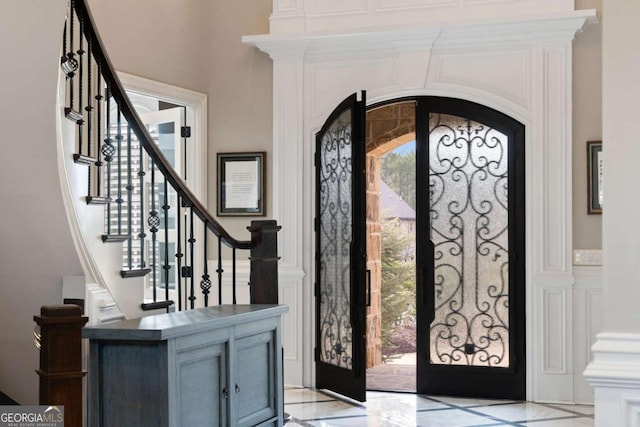 entrance foyer featuring french doors and a healthy amount of sunlight