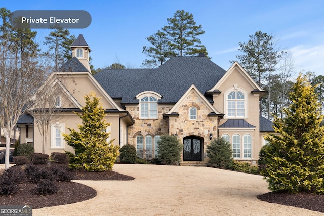 16143 Belford Dr, Alpharetta, GA 30004 - french provincial home featuring stucco siding, stone siding, and a standing seam roof