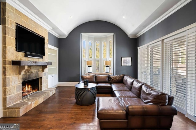 living room with lofted ceiling, a fireplace, crown molding, and dark wood-type flooring