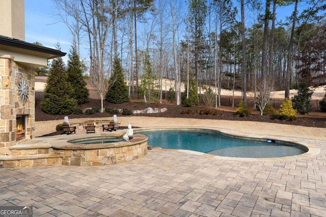 16143 Belford Dr, Alpharetta, GA 30004 - view of pool with an outdoor stone fireplace, a patio, and a pool with connected hot tub