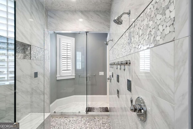 bathroom featuring a shower with door