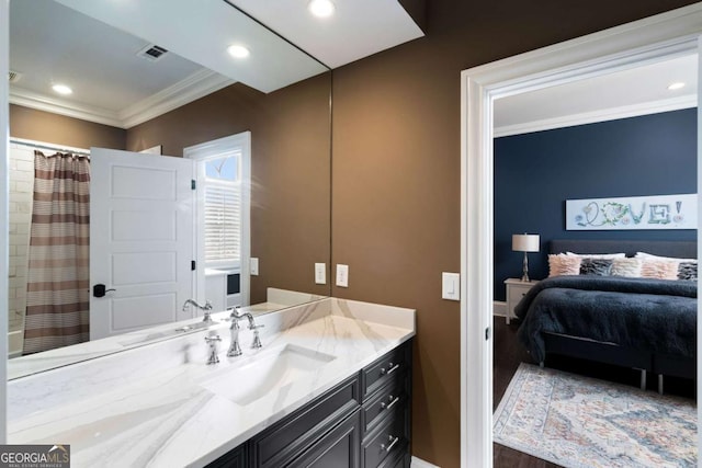 bathroom with walk in shower, ornamental molding, and vanity