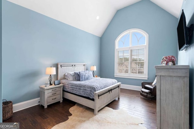 bedroom featuring lofted ceiling and hardwood / wood-style floors