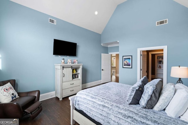 bedroom with high vaulted ceiling and dark hardwood / wood-style flooring