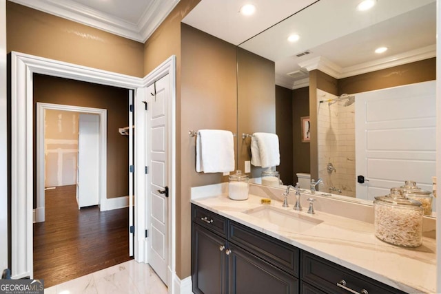 bathroom with ornamental molding, toilet, and vanity