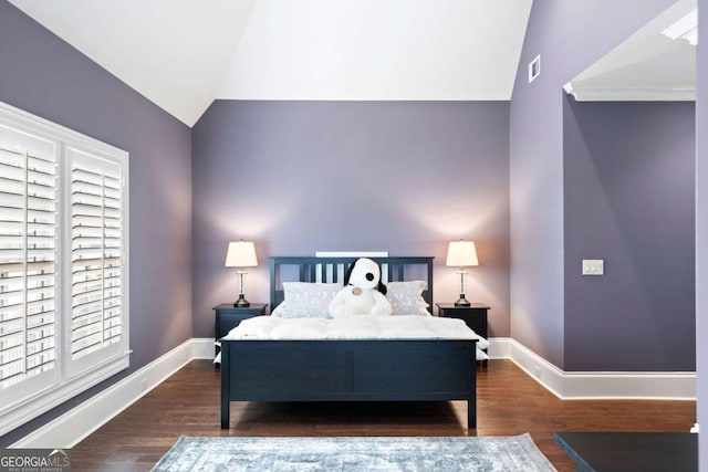 bedroom with vaulted ceiling and dark hardwood / wood-style flooring