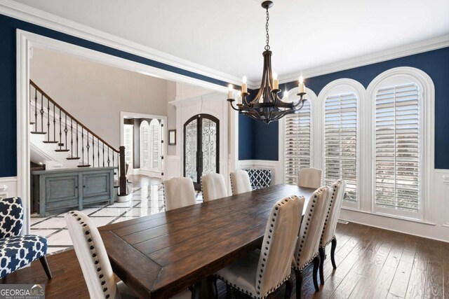 16143 Belford Dr, Alpharetta, GA 30004 - dining area featuring a chandelier, plenty of natural light, wainscoting, ornamental molding, and french doors