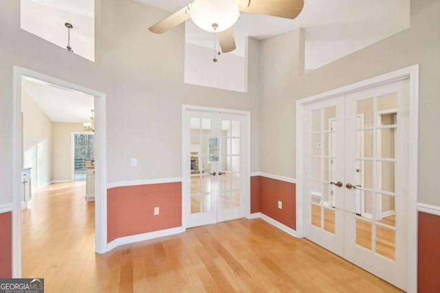 unfurnished room featuring french doors, ceiling fan, and hardwood / wood-style floors