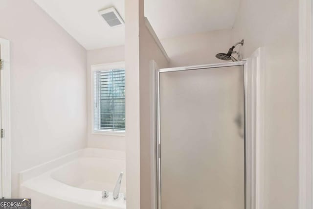 bathroom featuring independent shower and bath