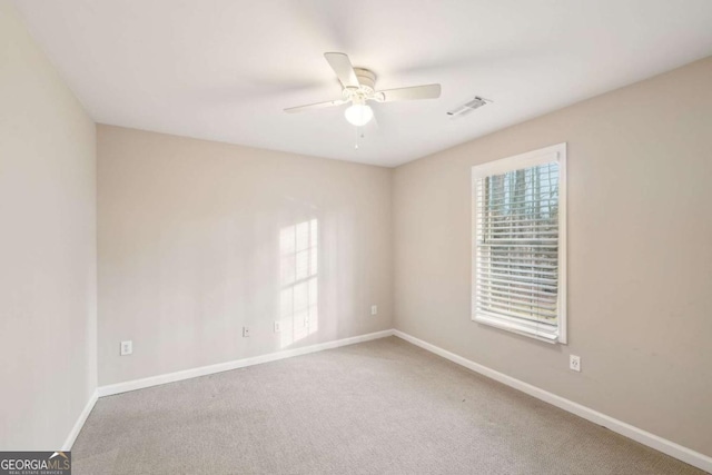 carpeted empty room with ceiling fan