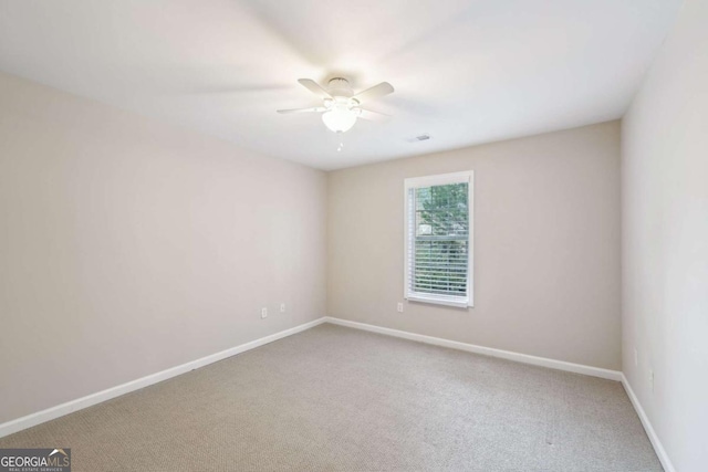 carpeted empty room featuring ceiling fan