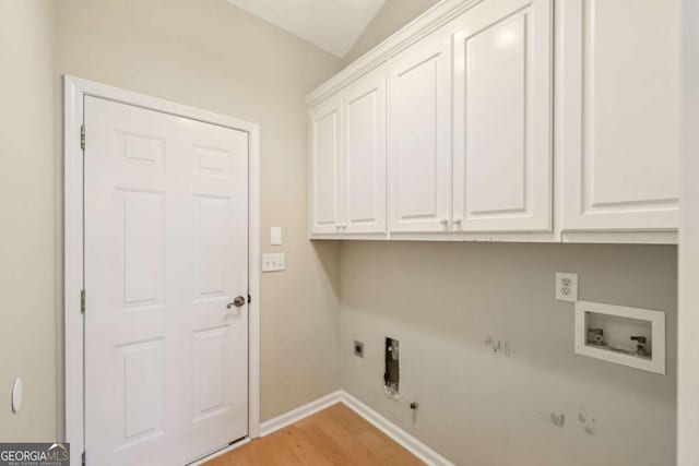 clothes washing area with gas dryer hookup, cabinets, washer hookup, electric dryer hookup, and light hardwood / wood-style flooring