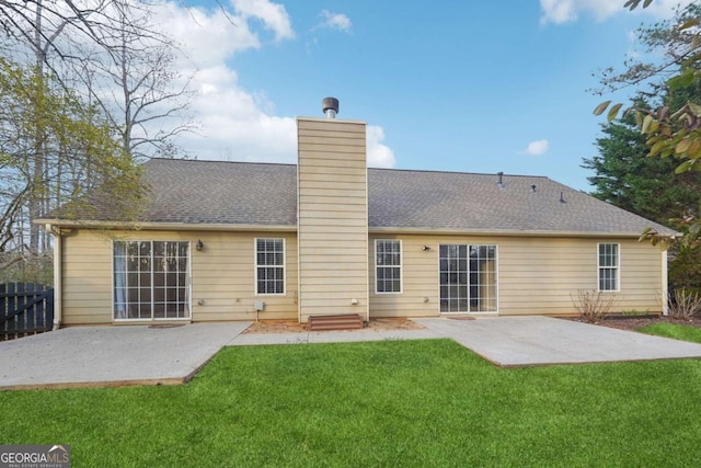 rear view of property featuring a patio and a lawn