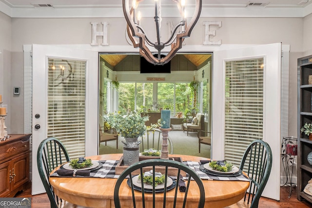 dining space featuring hardwood / wood-style floors and a notable chandelier