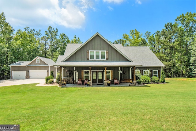 craftsman-style house featuring a garage, a front lawn, and covered porch