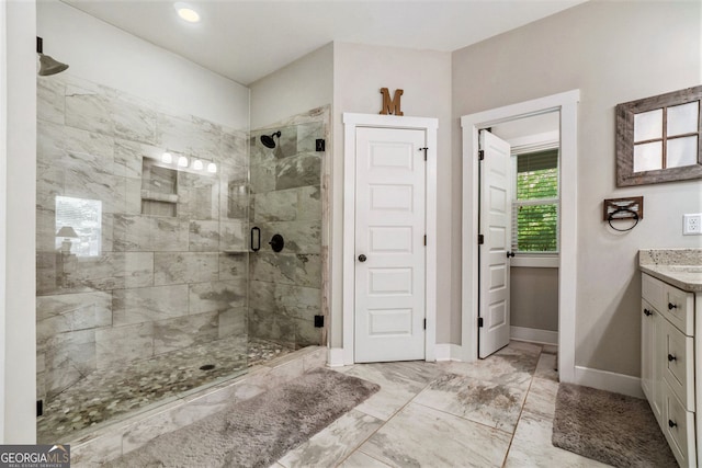 bathroom featuring vanity and a shower with door