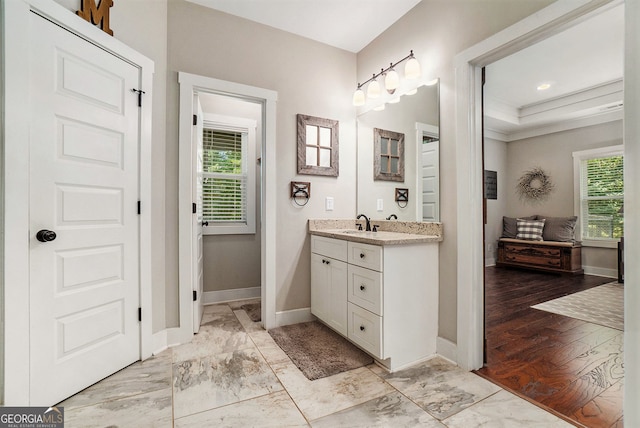 bathroom with a raised ceiling and vanity