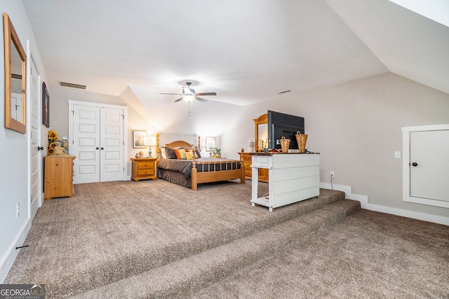 bedroom featuring vaulted ceiling, carpet flooring, ceiling fan, and a closet